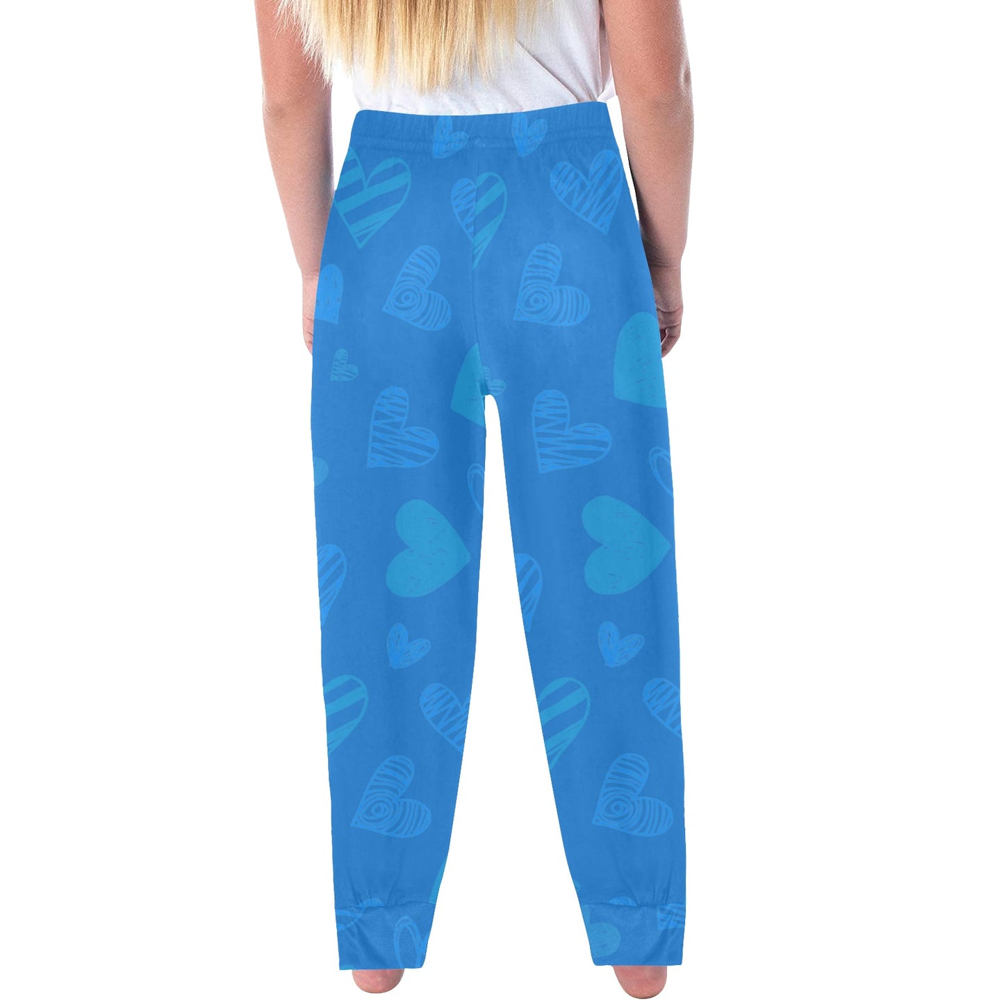 Girls all over print pajama bottoms "Hearts in Harmony" featuring colorful hearts on blue background.